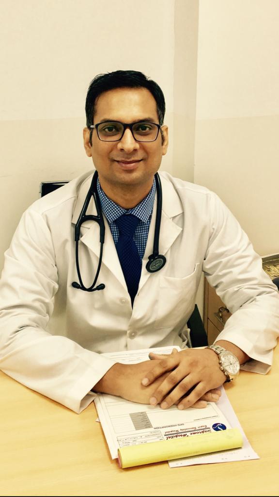 Dr. (Major) Ajit Pratap Singh seated at his desk in clinical practice